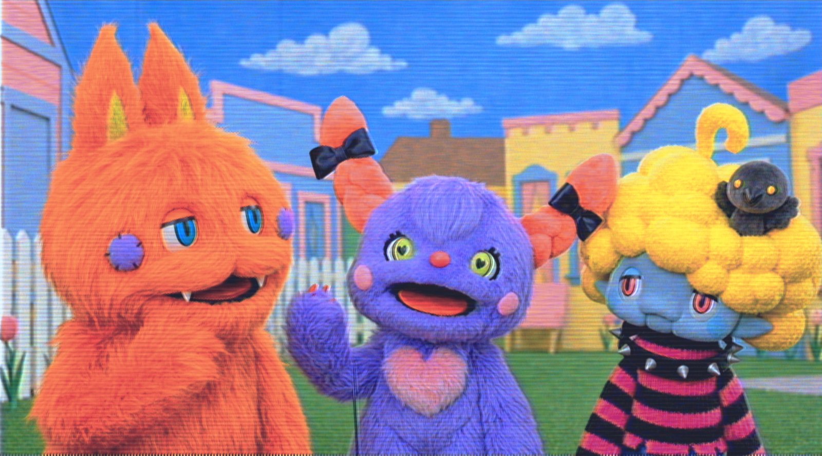 Three Huggles House characters on a pastel town street